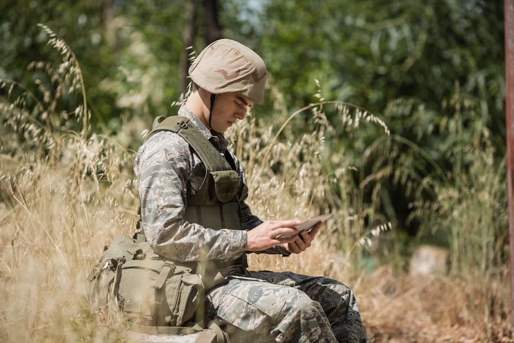 military soldier using 5G capable digital tablet